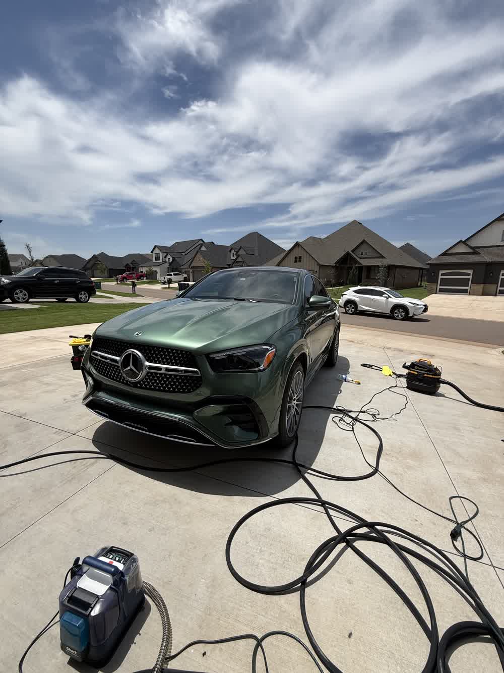 Green Mercedes GLE 450 coupe freshly detailed in a client driveway in the Oklahoma City metro